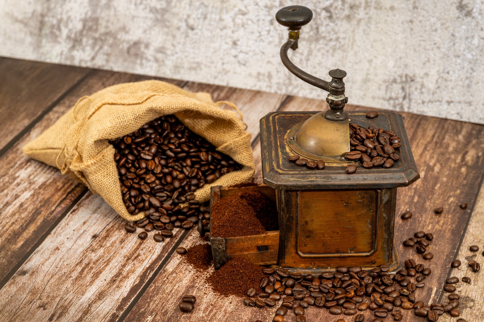 An,Old Fashioned,Coffee,Grinder,And,A,Bag,Of,Coffee,Beans An,Old Fashioned,Coffee,Grinder,And,A,Bag,Of,Coffee,Beans