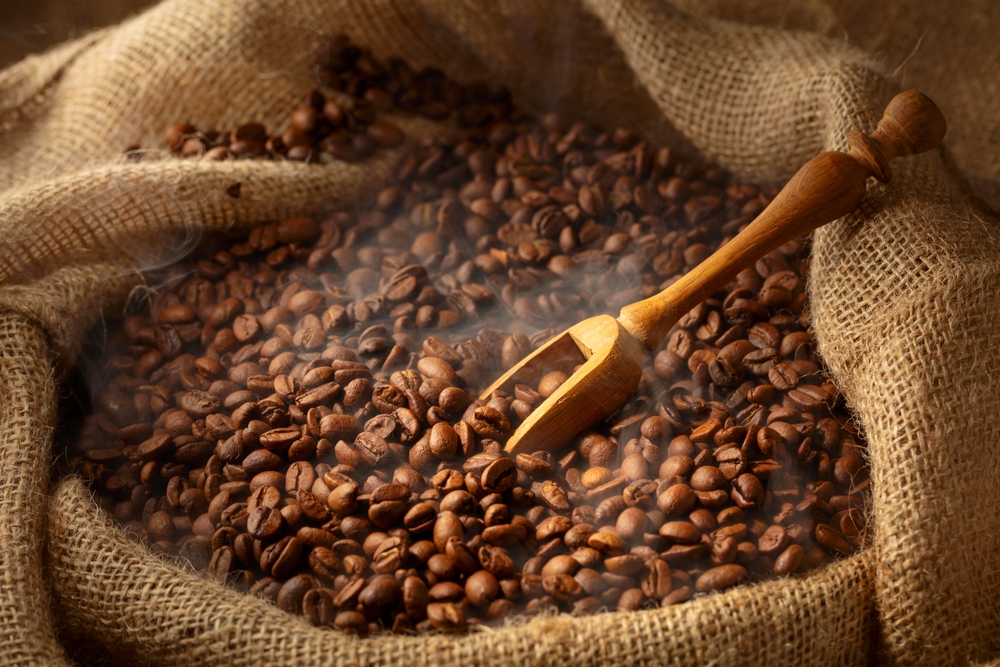 Fresh,Roasted,Coffee,Beans,And,Wooden,Scoop,In,Burlap,Bag.